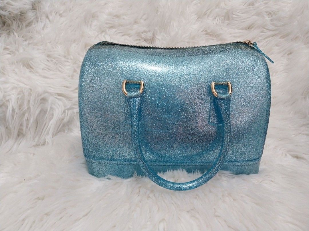 Furla Blue Glitter Candy Boston Bag (RARE) (Category: Luxury Bags & Wallets) located in Mandaluyong City. Submitted by ksjocana (Listing ID 1327956587, Image 1). Description: Original Retail Price: US $248/P13,650 Selling all my Authentic Furla bags from hubby during my Furla "phase" Needs a new home. With tag and lock. Join the rubber bag craze that has taken the fashion world by storm. This Blue glitter Furla tote is the accessory to have on a 