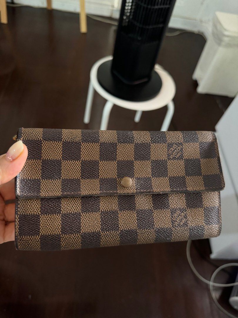 Louis Vuitton Damier Ebene Sarah Wallet (Category: Luxury Bags & Wallets) located in Makati City. Submitted by m_mna (Listing ID 1327892037, Image 2). Description: Louis Vuitton Sarah wallet Damier Ebene Condition:good B Card and coins pockets Size: 19 x 11 cm.