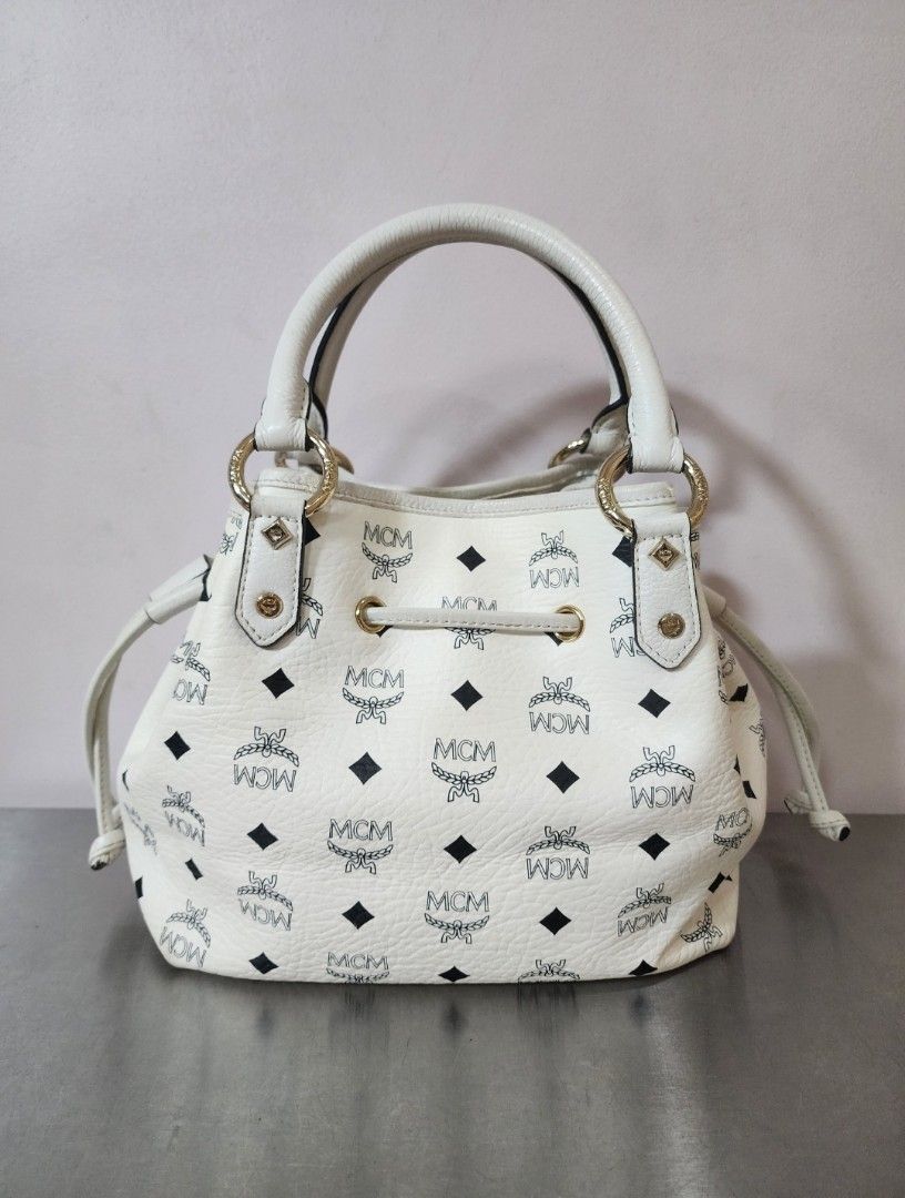 MCM Small Drawstring Bucket Bag (Category: Luxury Bags & Wallets) located in Valenzuela. Submitted by absolutelychick (Listing ID 1328018185, Image 3). Description: L 11.5" x W 5.75" x H 9.75" meron pong color transfer sa bandang ibaba sa front meron pong duminsa inner lining may maliit pong crack sa bottom part please check photo for reference jrs, lbc, j&t lalamove/grab ready.