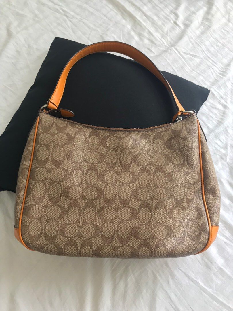 Coach Tangerine Hobo Bag (Category: Luxury Bags & Wallets) located in Makati City. Submitted by laineycops (Listing ID 1323582934, Image 2). Description: 3 compartments min wear zipper pull needs sewing min ballpen stain inside sold as is ***see about on profile.