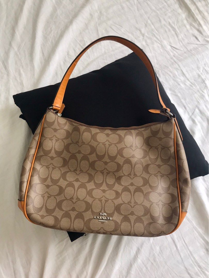 Coach Tangerine Hobo Bag (Category: Luxury Bags & Wallets) located in Makati City. Submitted by laineycops (Listing ID 1323582934, Image 1). Description: 3 compartments min wear zipper pull needs sewing min ballpen stain inside sold as is ***see about on profile.