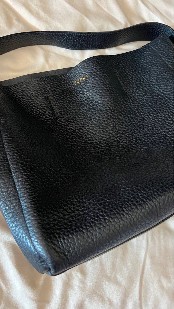 FURLA grainy black leather boho style bag (Category: Luxury Bags & Wallets) located in Caloocan City. Submitted by decluttermemore (Listing ID 1323576312, Image 2). Description: Gorgeous black leather grain and a spacious versatile bag. AUTHENTIC FURLA Italian Brand used gently and relatively clean inside with some marks from lipstick on side. please looks at pics outside is still good with no big scuffs on corners super spacious inside and can e