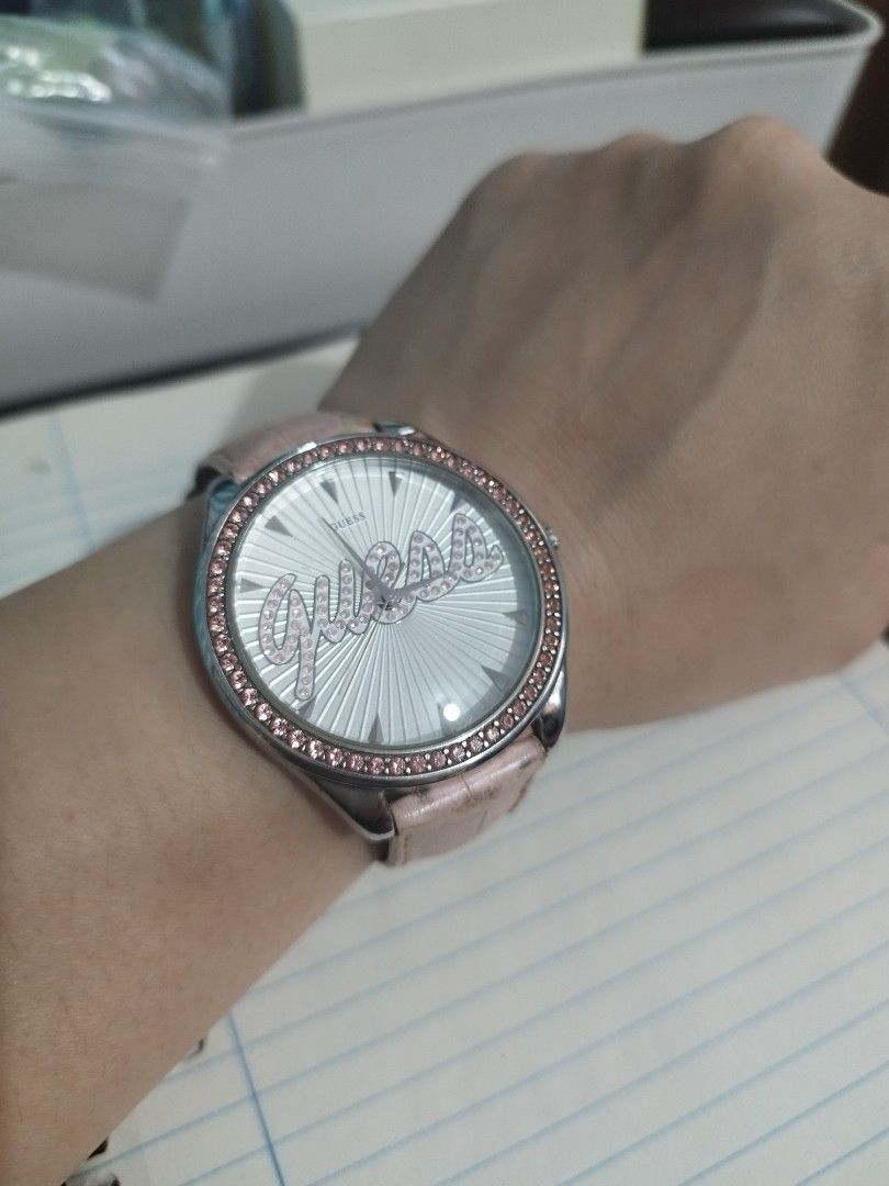 Guess 20th Anniversary Women's Watch - Silver Script Dial & Pink Strap (Category: Luxury Watches) located in Quezon City. Submitted by redragtag (Listing ID 1323718324, Image 1). Description: GUESS 20th Anniversary Edition Women's Watch – Silver Script Dial & Pink Strap Description: Selling an authentic, limited-edition GUESS 20th Anniversary quartz watch. This eye-catching fashion piece features a silver sunray dial with a prominent crystal-stud