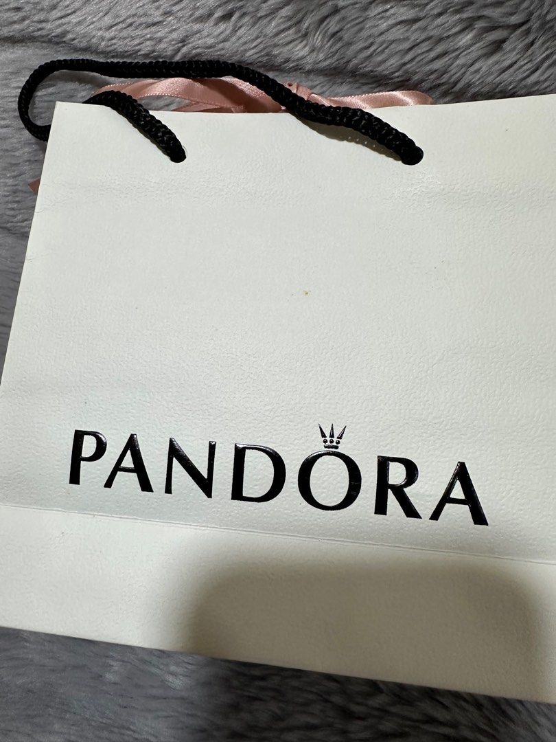 Pandora Paper Bag (Category: Luxury Bags & Wallets) located in Quezon City. Submitted by jshoppppp (Listing ID 1323775460, Image 2). Description: Used once. Has a small stain - see pic. 6x6 BPI or BDO SF c/o buyer PIOG.