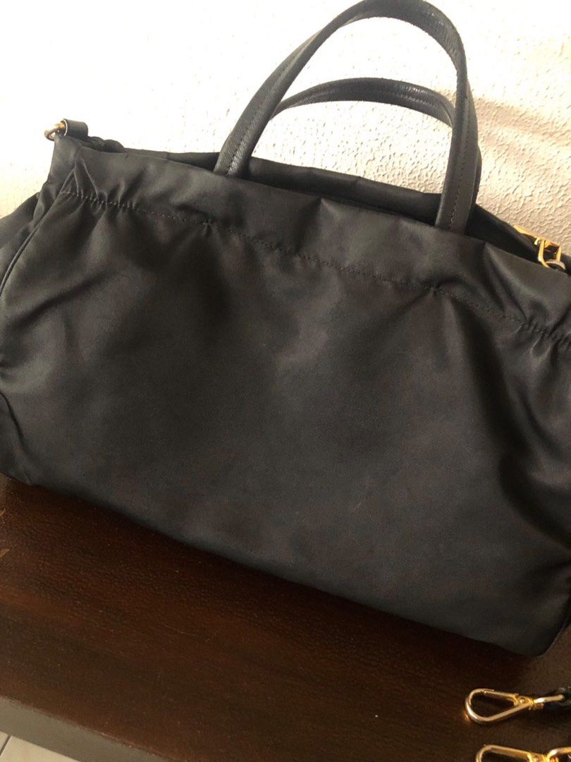 2 way nylon bag (Category: Luxury Bags & Wallets) located in Quezon City. Submitted by jaziman20249087 (Listing ID 1324251133, Image 2). Description: PRADA B1843M Black 2-way tessuto and saffiano B1843M Measurements 13” x 8” x 5” Flaws: Cracked handles (pls see photo), long strap still good, Tarnished hardware but zipper pulls are still good Includes: Detachable and adjustable strap Dustbag Cards Paper bag .