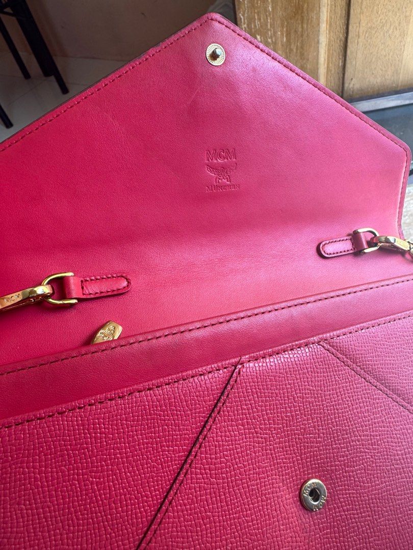 Rush!!! Authentic MCM Sling bag (pink) (Category: Luxury Bags & Wallets) located in Cavite. Submitted by leylamm (Listing ID 1324418549, Image 3). Description: Authentic. With minor discoloration at the back but still in very good condition. Spacious. Can fit your Pro Max phone and passports. Sling is removable, can also be used as clutch. .