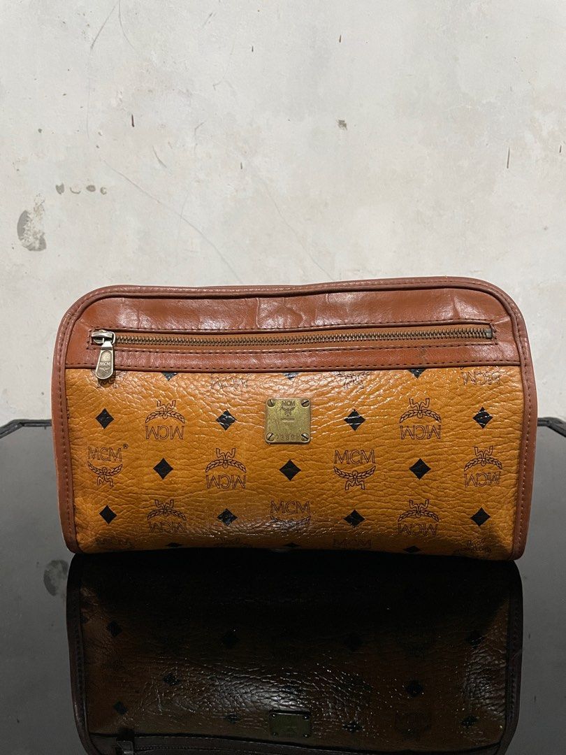 Vintage Mcm Visetos Clutch Bag (Category: Luxury Bags & Wallets) located in Quezon City. Submitted by Prive_Online (Listing ID 1324410837, Image 1). Description: WTS! - -Vintage Mcm Visetos Clutch Bag -Guaranteed Authentic -Size: Medium -Dimensions: H 7.5in x L 11.5in x W 3in -Signs of use -Excellent condition outside of the bag -Riri Zipper - Issues: Main Pocket Crack Leathers and tag is pealed off, Second pocket minor Leather cracks above the t