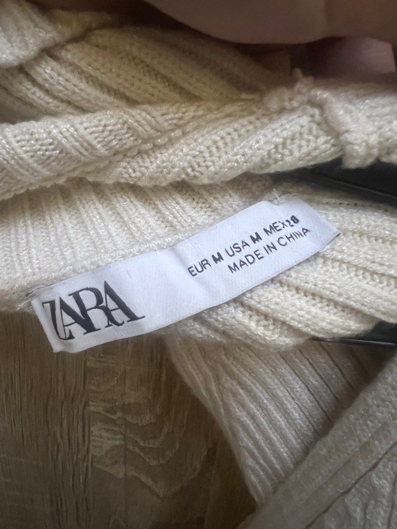 Zara Ecru Knit Cut out Sweater (Category: Longsleeves) located in Manila. Submitted by lunaluvgood (Listing ID 1324518094, Image 2). Description: Medium on tag Turtleneck Authentic When worn inspo posted sa 3rd pic Rare 💗 No issues RFS: Decluttering.