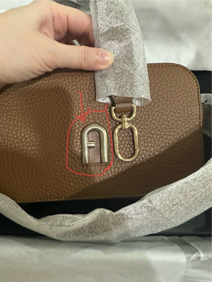 Furla Camera Bag (Category: Luxury Bags & Wallets) located in Manila. Submitted by noweenj (Listing ID 1344895724, Image 2). Description: Brand New Unused. FAS of the bag is the discolored logo at front as seen in pic. Hence the low price. .