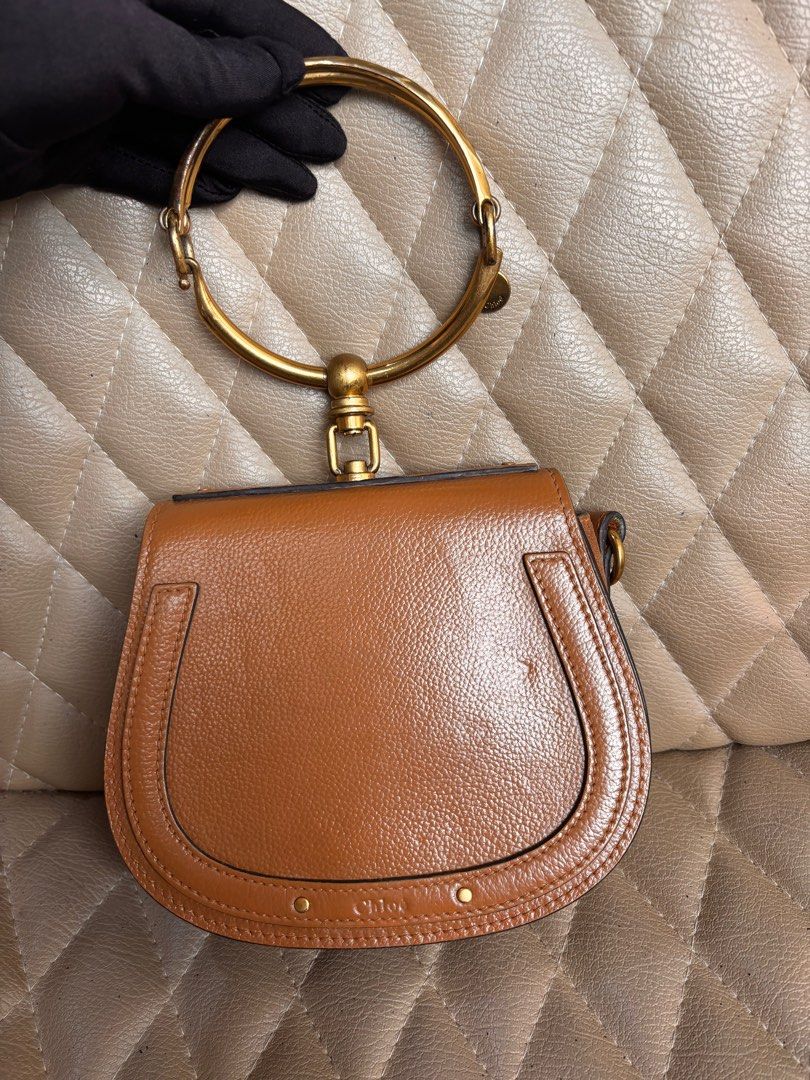 Chloe Bag Nile Bracelet Bag (Category: Luxury Bags & Wallets) located in Quezon City. Submitted by dmanille (Listing ID 1346754612, Image 1). Description: Authentic Chloe Bracelet Bag NIlE Cross body, bracelet bag With removable strap Fresh from bag spa Recolored from beige to light brown With a little dent infront due to storage With some stains inside the bag Perform own authentication procedure before purchase. .