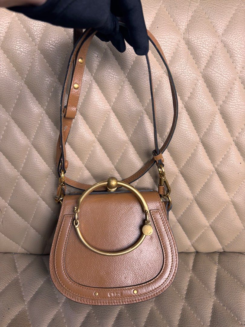 Chloe Bag Nile Bracelet Bag (Category: Luxury Bags & Wallets) located in Quezon City. Submitted by dmanille (Listing ID 1346754612, Image 3). Description: Authentic Chloe Bracelet Bag NIlE Cross body, bracelet bag With removable strap Fresh from bag spa Recolored from beige to light brown With a little dent infront due to storage With some stains inside the bag Perform own authentication procedure before purchase. .