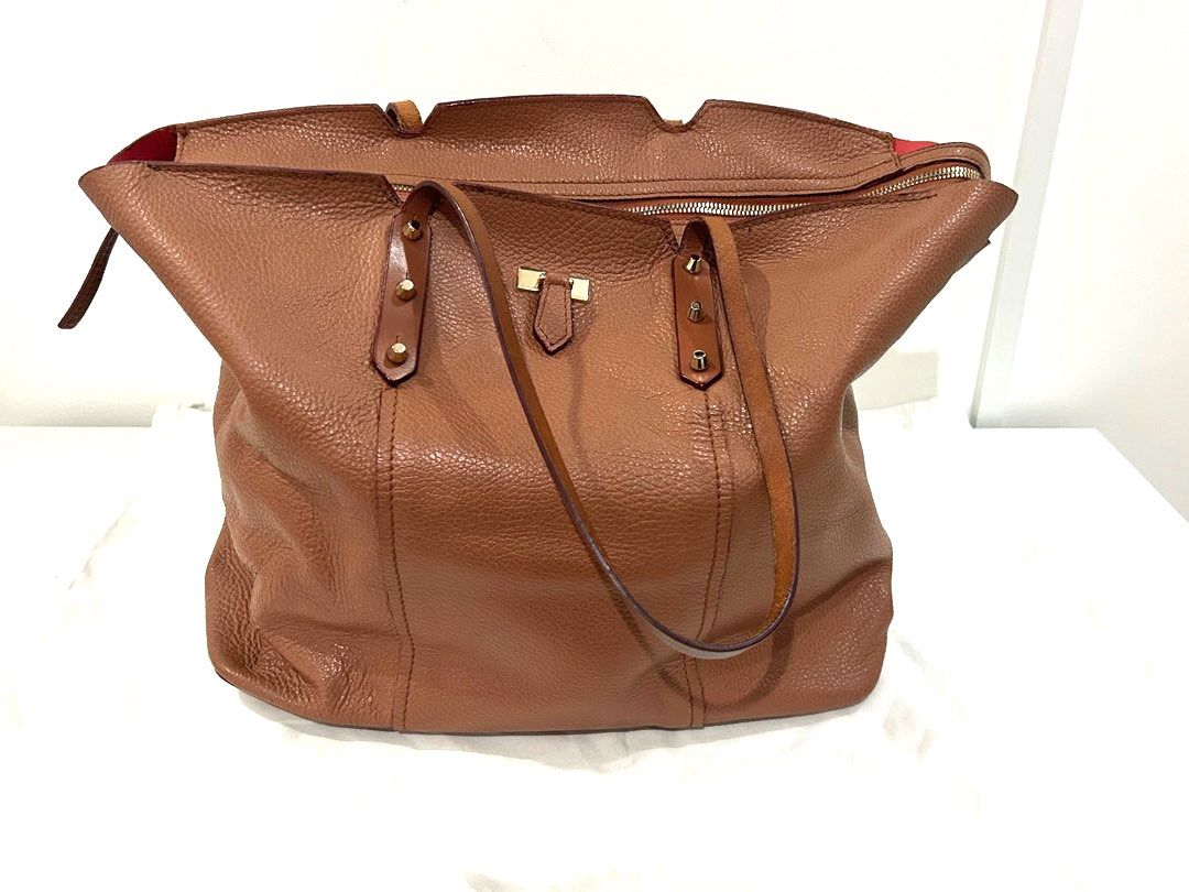 Authentic Furla Leather Tote Bag in Camel (Category: Luxury Bags & Wallets) located in Paranaque City. Submitted by cfcisco (Listing ID 1346911074, Image 1). Description: Authentic Furla Leather Tote Bag in Camel Condition Used With Dust Bag Leather in Excellent Condition Soft Leather With inside pocket Pen stains on the inside - please refer to the pictures Small stain outside bottom portion - please refer to the pictures. .