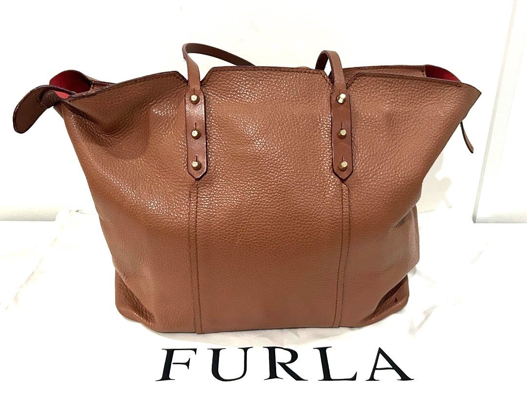 Authentic Furla Leather Tote Bag in Camel (Category: Luxury Bags & Wallets) located in Paranaque City. Submitted by cfcisco (Listing ID 1346911074, Image 2). Description: Authentic Furla Leather Tote Bag in Camel Condition Used With Dust Bag Leather in Excellent Condition Soft Leather With inside pocket Pen stains on the inside - please refer to the pictures Small stain outside bottom portion - please refer to the pictures. .