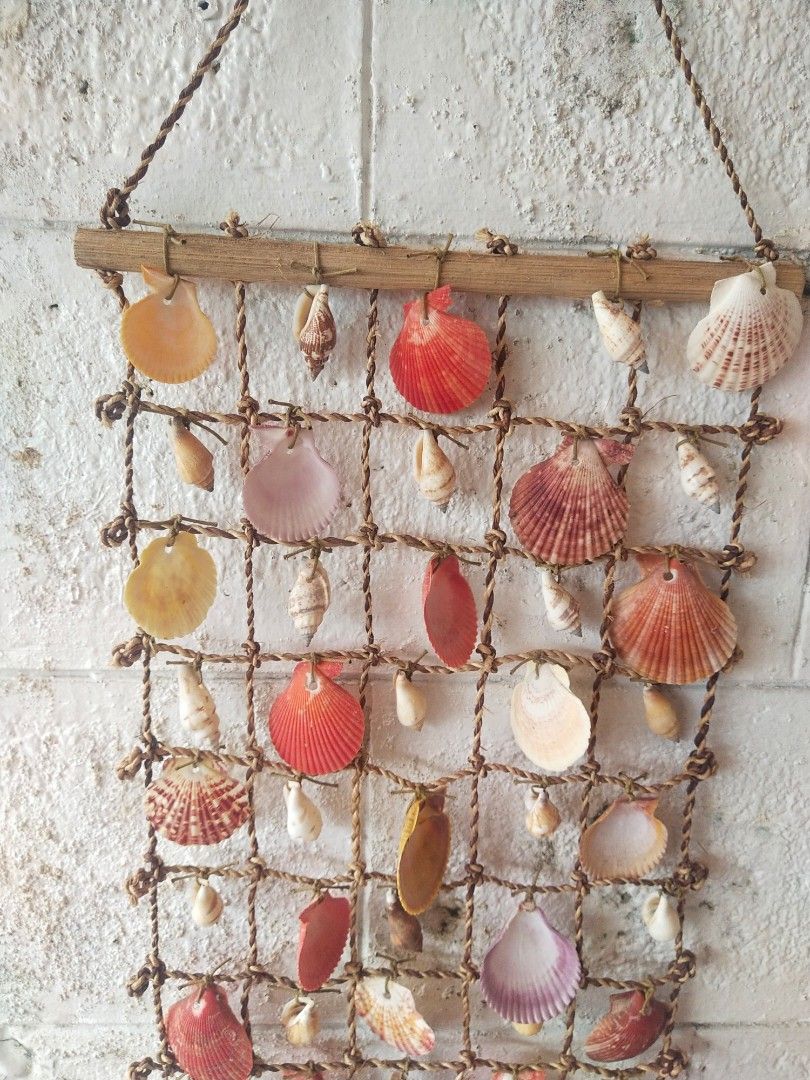 Collectible "Sea shells Hanging Display"/Nice & Interesting to display! (Category: Wall Decor) located in Del Monte. Submitted by zurckram777 (Listing ID 1346965838, Image 3). Description: Very nice and interesting sea shells hanging display. For man cave,bedroom wall,office wall or bathroom decor. Wonderful Pinoy craft. Measures about 21 by 11 inches. Has some slight signs of use,wear and storage. Still in VG cond. (WIRE).