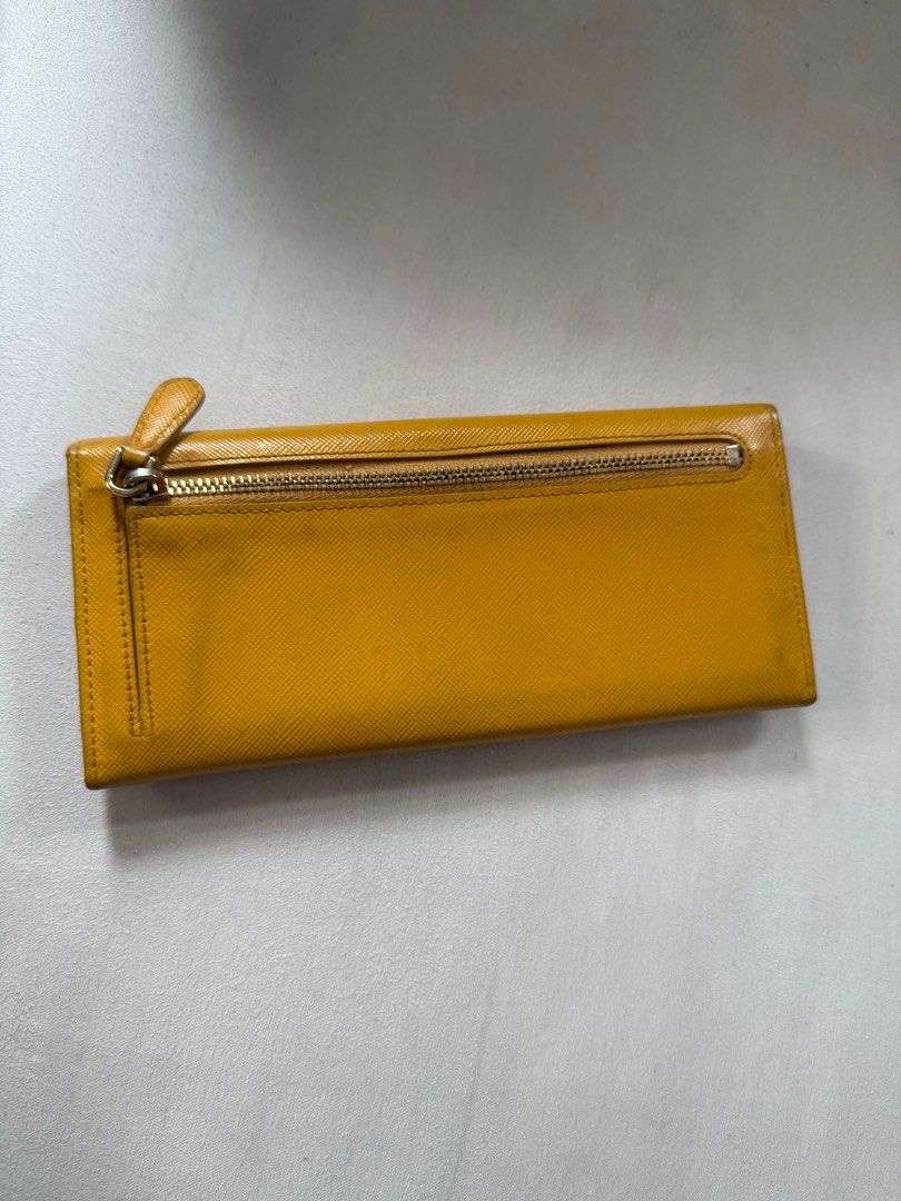 Prada Wallet (Category: Luxury Bags & Wallets) located in Quezon City. Submitted by ak3isha (Listing ID 1346921049, Image 2). Description: Color: Yellow *signs of usage are visible.