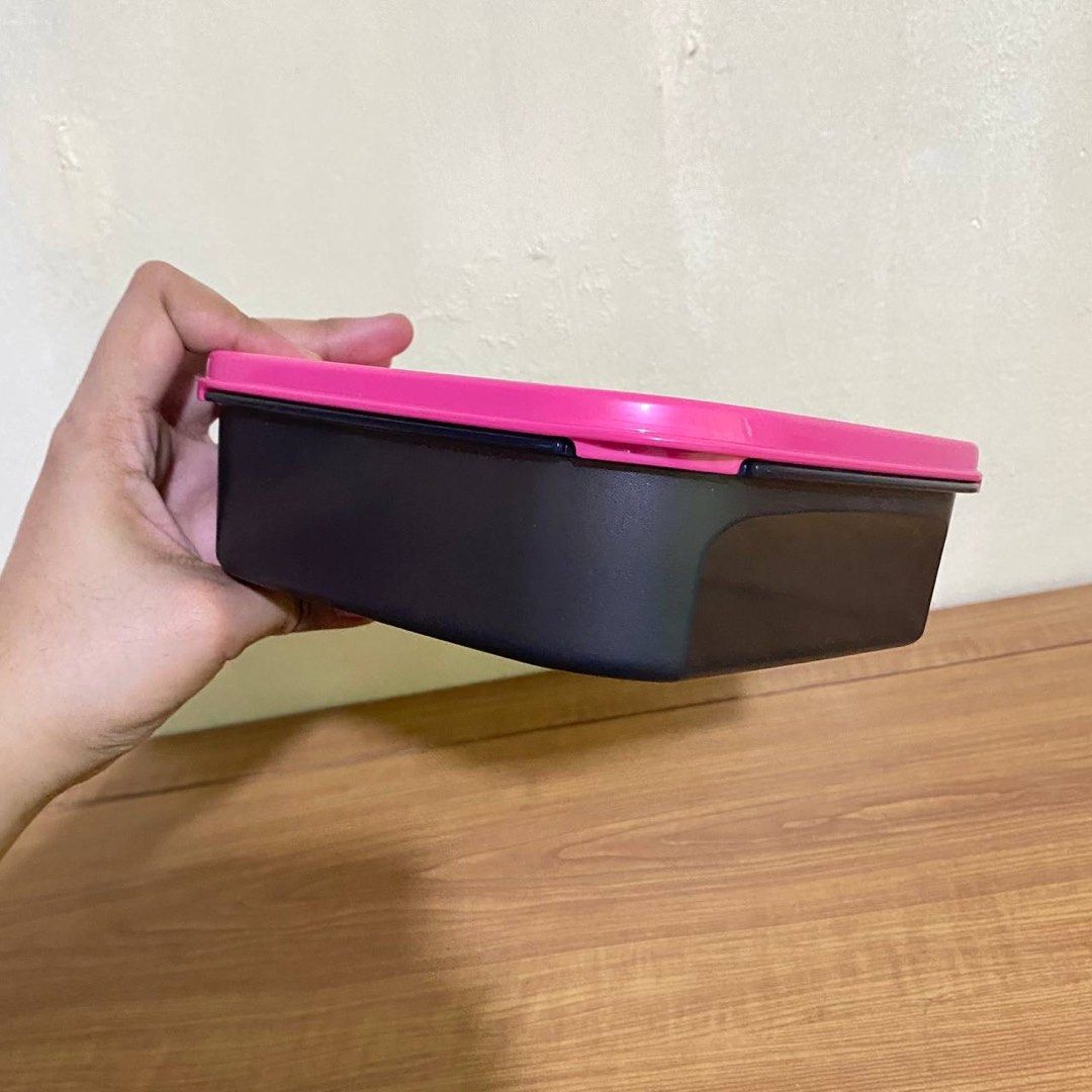 TUPPERWARE BLACK PINK SQUARE CONTAINER (1L) (Category: Food Organization & Storage) located in Quezon City. Submitted by xtian.store (Listing ID 1347081305, Image 2). Description: TUPPERWARE BLACK PINK SQUARE CONTAINER (1L) BRAND NEW AND ORIGINAL 7 x 7 inches Height: 2.5 inches.