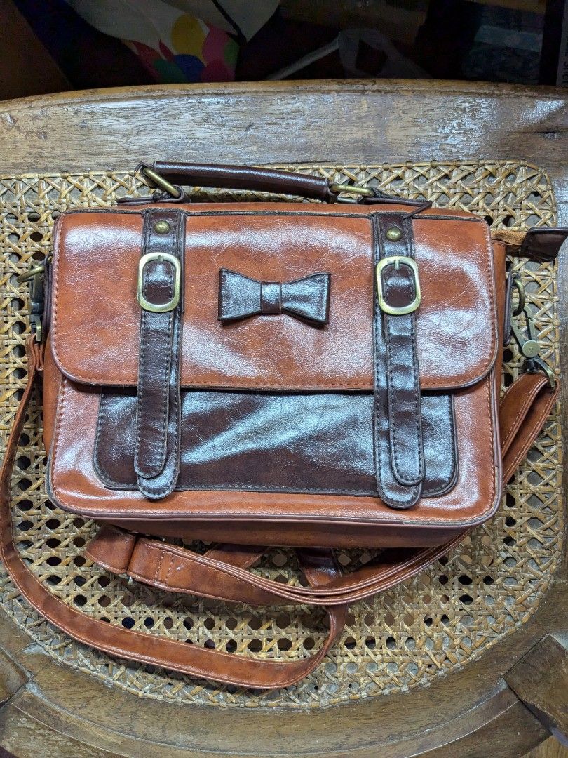 Ecosusi Leather Bow Messenger Bag (Category: Cross-body Bags) located in Quezon City. Submitted by chocobutterpie (Listing ID 1347167891, Image 1). Description: Condition: -Well-loved item. There are signs of wear on the edges as shown in photos. Description from Ecosusi -Exquisite bow decoration; -Antique gold-tone hardware; -Multiple storage compartments The Women's Faux Leather Bow Messenger Bags is both elegant and functional. The vintage sil