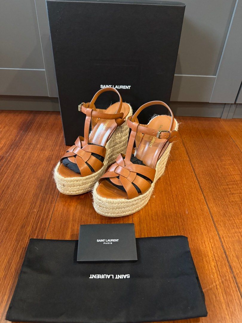 SAINT LAURENT Tribute 130 leather espadrilles (Category: Sneakers & Footwear) located in Muntinlupa City. Submitted by bagstagram (Listing ID 1347378025, Image 1). Description: Saint Laurent’s Tribute espadrilles are a warm-weather staple. Finished with 130 wedge heels, this style has been crafted in Spain in a timeless tan colorway for effortless sunshine chic. Upper: calf leather Lining: leather Sole: leather insole, rubber sole Toe shape: almo