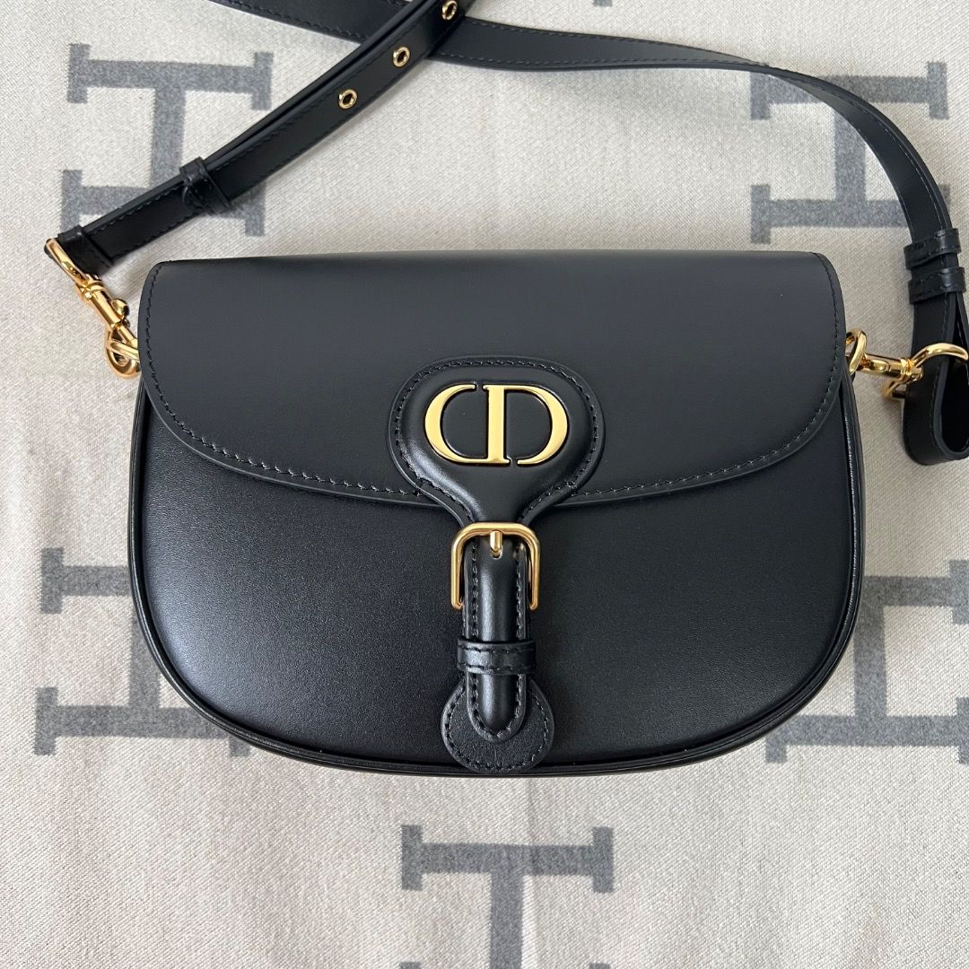 Dior Bobby Medium Bag Black Box Calfskin (Category: Luxury Bags & Wallets) located in Antipolo. Submitted by chanchimj (Listing ID 1338782047, Image 1). Description: The medium silhouette is crafted from cognac-colored box calfskin with a supple suede calfskin interior, and is enhanced by antique gold-finish metal hardware. Its removable and adjustable shoulder strap has a military-inspired buckle and allows it to be carried by hand, worn over th