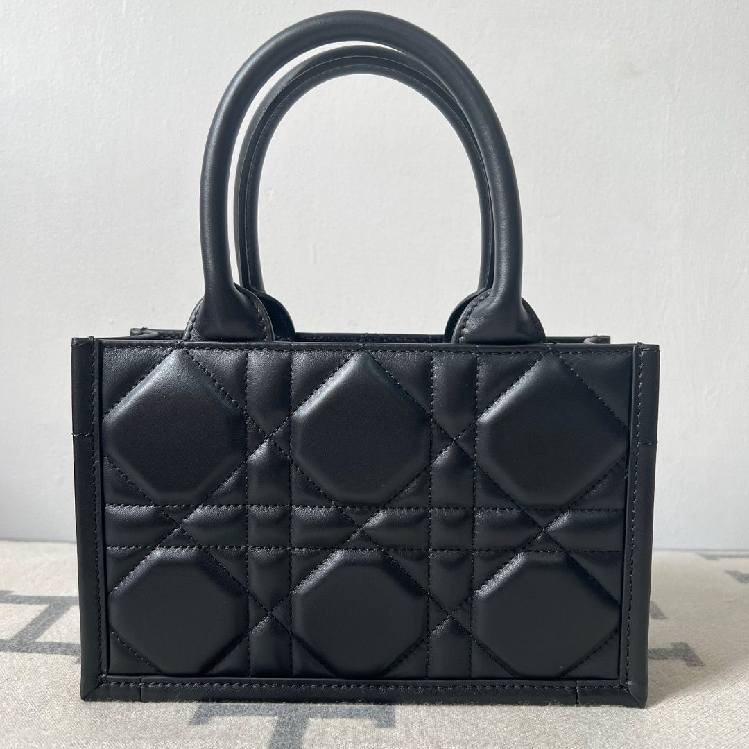 Dior Mini Book Tote Black Macrocannage Calfskin (Category: Luxury Bags & Wallets) located in Antipolo. Submitted by chanchimj (Listing ID 1338796607, Image 2). Description: the miniature style features an adjustable and removable strap that allows it to be carried by hand, worn over the shoulder or crossbody. Dimensions: 21.5 x 13 x 7.5 cm.