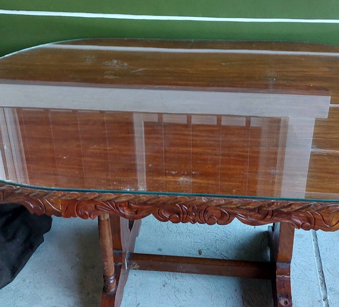 Narra Dining Table and Chairs / Narra 6 seater dining table set (Category: Tables & Sets) located in Quezon City. Submitted by gcc216 (Listing ID 1347850388, Image 3). Description: A beautiful 6 seater NARRA Dining Set . Made of Narra wood with Natural finish. Hand-carved design , Oval shape with glass top made for the table . Glass top is worth 5,9 already. 6 chairs also with design. size of table in inches: L 60 xW 36 xH 29 Only flaw: one rod i