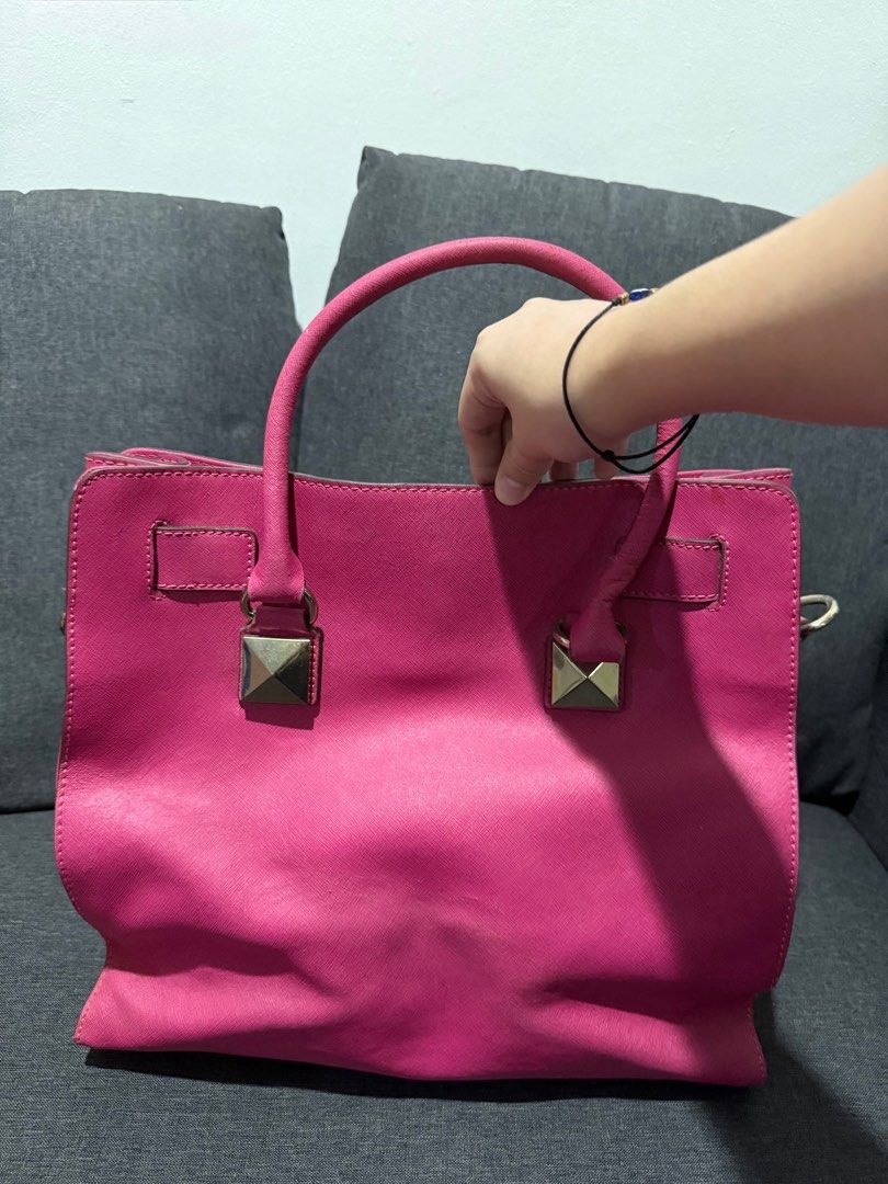 Michael Kors (MK) Leather Studded Pink Bag (Category: Luxury Bags & Wallets) located in Manila. Submitted by pheta (Listing ID 1348398286, Image 2). Description: RFS: Decluttering Bag has been deformed a bit (refer to the back pictures) Authentic MK Leather Studded Large North South Hamilton Tote.