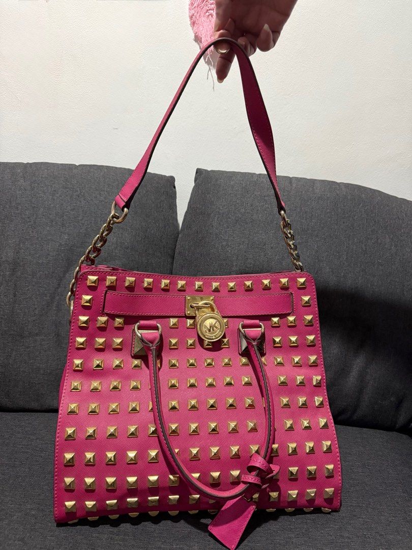 Michael Kors (MK) Leather Studded Pink Bag (Category: Luxury Bags & Wallets) located in Manila. Submitted by pheta (Listing ID 1348398286, Image 1). Description: RFS: Decluttering Bag has been deformed a bit (refer to the back pictures) Authentic MK Leather Studded Large North South Hamilton Tote.