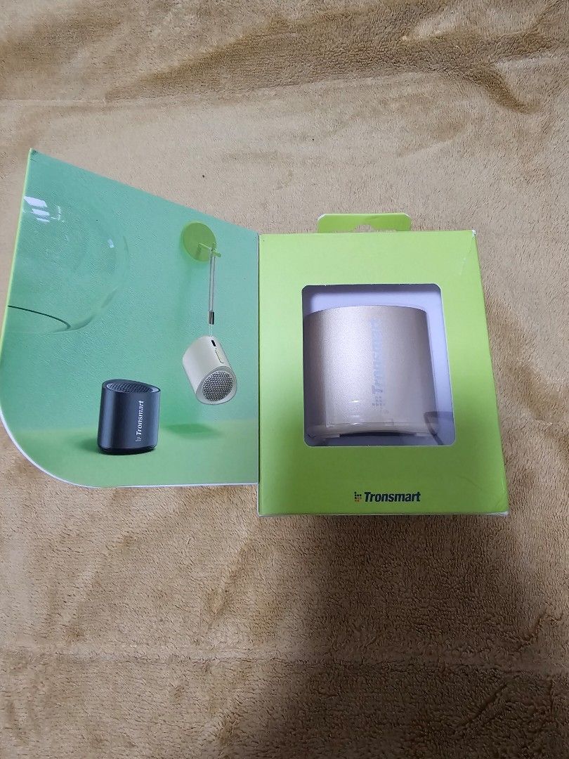 Tronsmart Nimo Bluetooth Speaker (Gold) (Category: Portable Audio Accessories) located in San Juan City. Submitted by jenteria10 (Listing ID 1348274717, Image 2). Description: Tronsmart Nimo Bluetooth Speaker Color: Gold IPX7 Waterproof Can be paired with another Nimo speaker for stereo sound Brand new, purchased October 2024 ut never used (extra unit intended for gifting) Slight damage on box lid when opening to test the speaker.