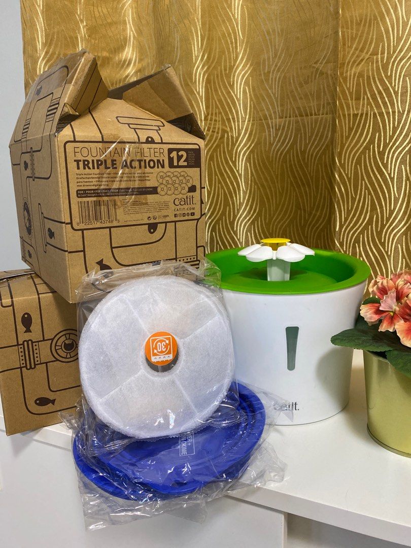 Catit Water Fountain and Filter (Category: Homes & Other Pet Accessories) located in Bacoor. Submitted by ampetvet (Listing ID 1345053292, Image 1). Description: Catit 3L Flower Water Fountain for dogs and cats - used - 200 Catit Fountain Filter Triple Action - set of 2 filters - 200 php 1 box with 12 packs of Catit Fountain Filter Triple Action - unopened box - 2,000php Everything: 17 filters and water fountain - 2,300php with 2 free big collaps