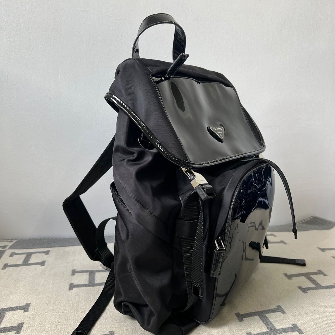 Prada Tessuto Nylon Patent Backpack 2VZ135 (Category: Luxury Bags & Wallets) located in Antipolo. Submitted by chanchimj (Listing ID 1334480226, Image 2). Description: Prada Re-Nylon with shiny leather backpack Integrating innovative recycled nylon fabric Re-Nylon with shiny leather, highlighting the fusion charm of contemporary fashion and pragmatism Large capacity, fashionable and versatile, easy to use for daily life and travel 2VZ135 Size: wi