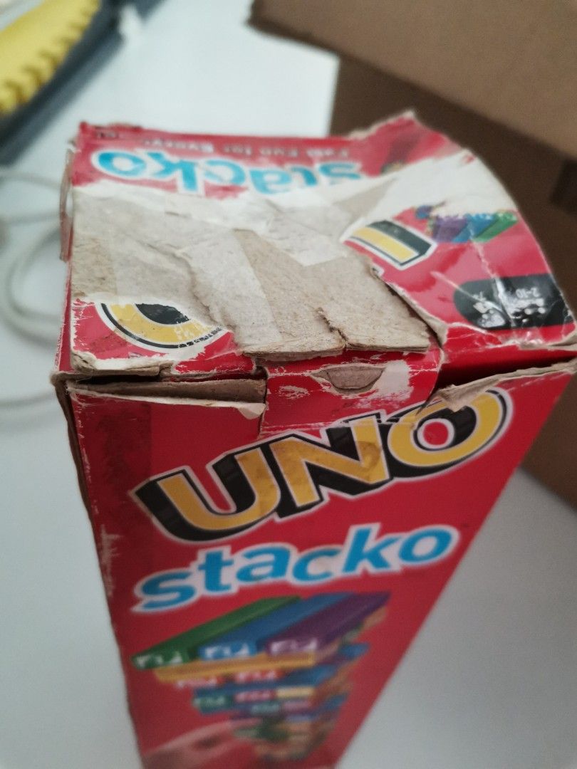 UNO stacko (Category: Board Games & Puzzles) located in Singapore. Submitted by pretty_mama10 (Listing ID 1345006167, Image 2). Description: box is heavily damaged as seen in pic 2 but the bricks have no major flaws. only played with it multiple times.