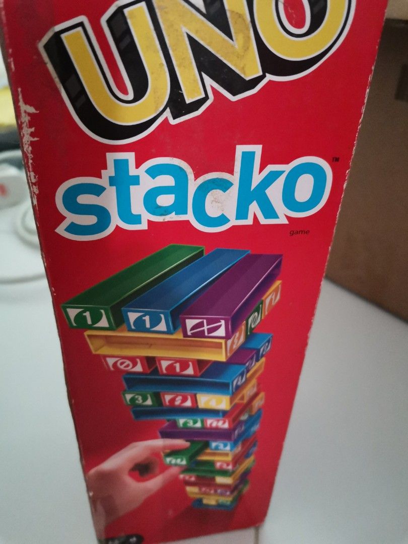 UNO stacko (Category: Board Games & Puzzles) located in Singapore. Submitted by pretty_mama10 (Listing ID 1345006167, Image 1). Description: box is heavily damaged as seen in pic 2 but the bricks have no major flaws. only played with it multiple times.
