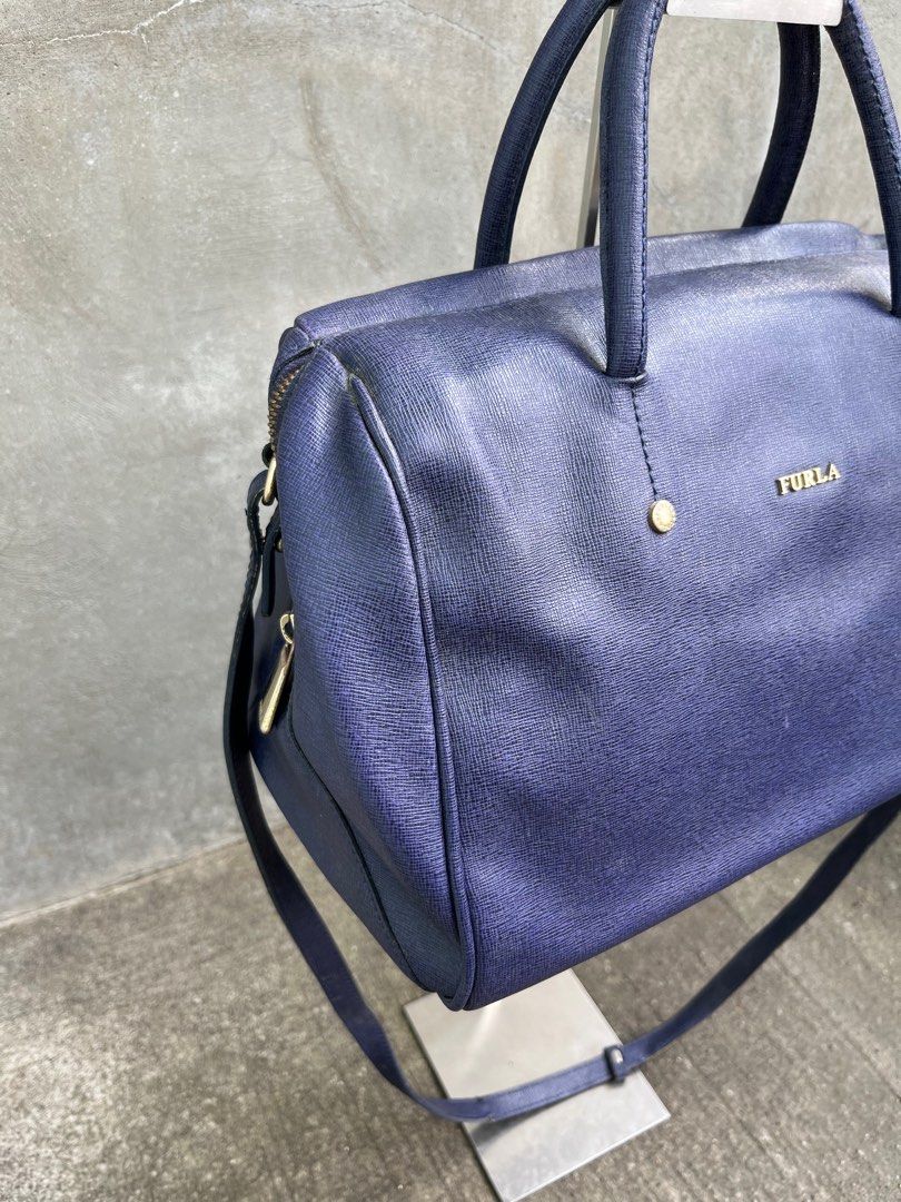 Furla Midi Candy Bag (Category: Luxury Bags & Wallets) located in Baguio. Submitted by lordeidara (Listing ID 1348719849, Image 2). Description: Rank B Leather Scuffs and scratches Needs professional leather cleaning interior and exterior Stains on interior Slight damage all over the strap Color:Blur Material:Leather Size on tag: Length:12 Width:7.5 Height:9 Strap Length:42.5 Number of Pockets:.