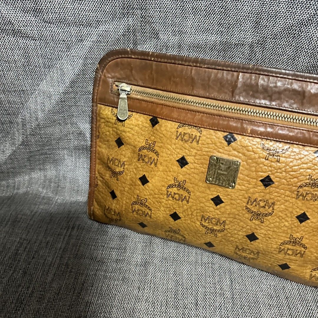 MCM clutch bag (Category: Luxury Bags & Wallets) located in Manila. Submitted by greyinfash06839 (Listing ID 1348788334, Image 3). Description: 🤍Price: 5,900 pesos only 🤍Item: MCM clutch bag 🤍Brand: MCM 🤍Matirial: Leather 🤍Quality: Original 🤍color: Yellow 🤍Size: Medium 🤍Dimension. H: 8 L: 11 W: 3 🤍Sex: Unisex 🤍Issue: lining and inside 🤍Condition Rate: 6/10 🤍Other info:.