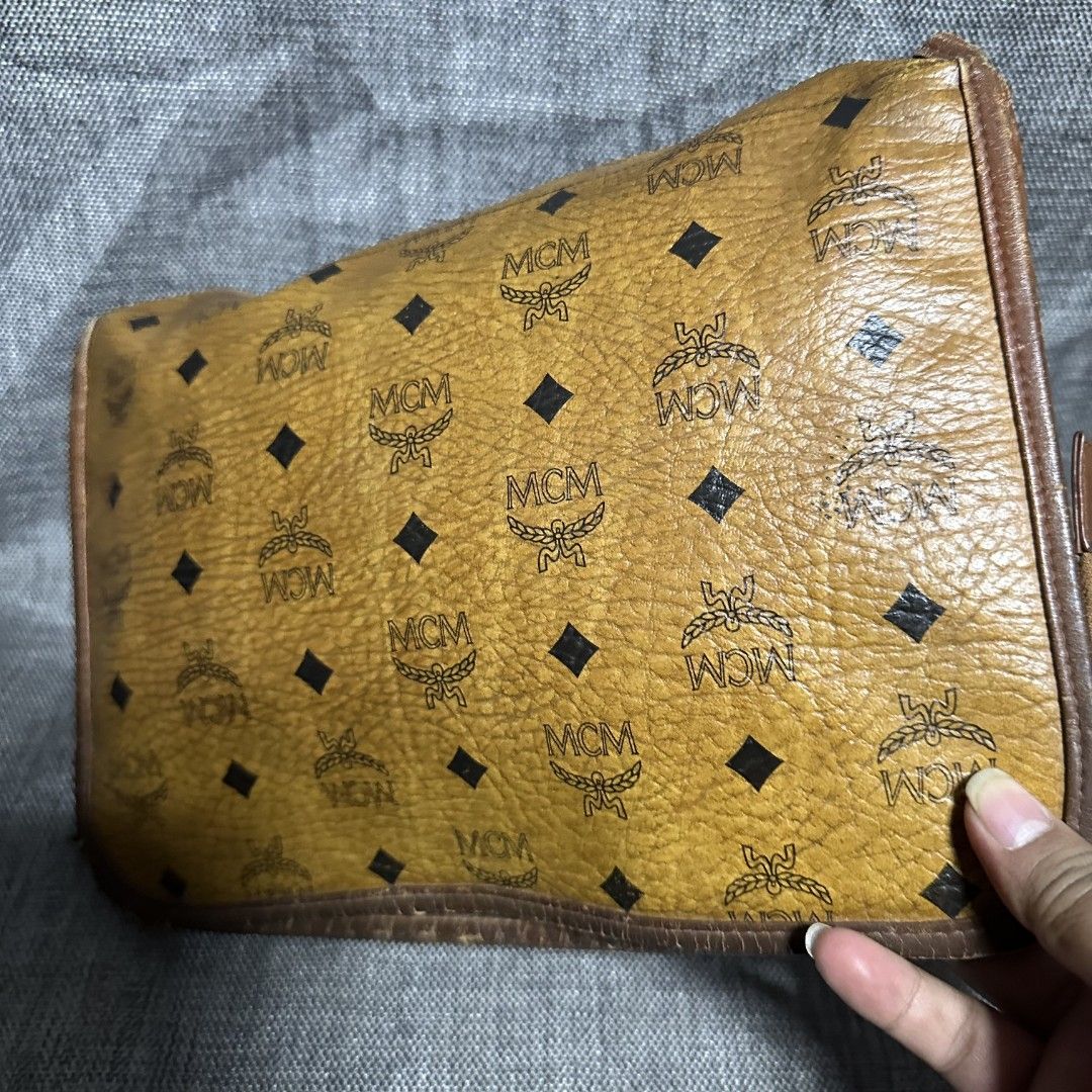 MCM clutch bag (Category: Luxury Bags & Wallets) located in Manila. Submitted by greyinfash06839 (Listing ID 1348788334, Image 2). Description: 🤍Price: 5,900 pesos only 🤍Item: MCM clutch bag 🤍Brand: MCM 🤍Matirial: Leather 🤍Quality: Original 🤍color: Yellow 🤍Size: Medium 🤍Dimension. H: 8 L: 11 W: 3 🤍Sex: Unisex 🤍Issue: lining and inside 🤍Condition Rate: 6/10 🤍Other info:.