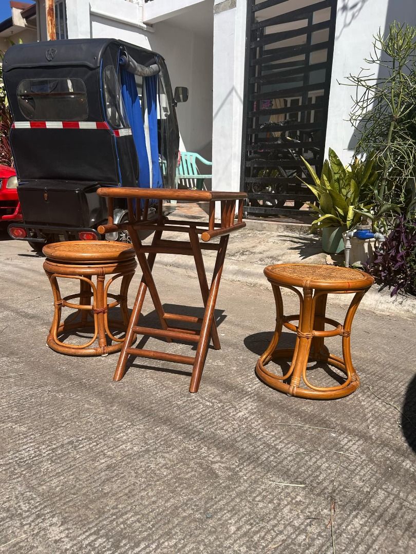 Rattan Foldable Table Set with 2 Stools (Category: Tables & Sets) located in General Trias. Submitted by tenshijapan (Listing ID 1348676453, Image 1). Description: Add a touch of rustic charm to your space with this beautiful rattan table set, perfect for both indoor and outdoor use. The set includes a unique foldable rattan table and two matching stools, designed with a timeless and stylish aesthetic. Whether you're hosting guests or enjoying a 
