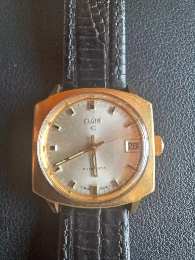Elgin Sunburst Silver Dial, Hefty Gold Squared Case (Category: Luxury Watches) located in Manila. Submitted by timearcph (Listing ID 1348889271, Image 3). Description: Elgin Sunburst Silver Dial, Hefty Gold Squared Case with Curved Top and Bottom, Date, Automatic, 31.5x31.5mm Size 31.5 x 31.5mm (without crown and without lugs) Dial : Spotless silver dial with a light sunburst pattern with black tick markers on outer ring on smooth silver backgrou