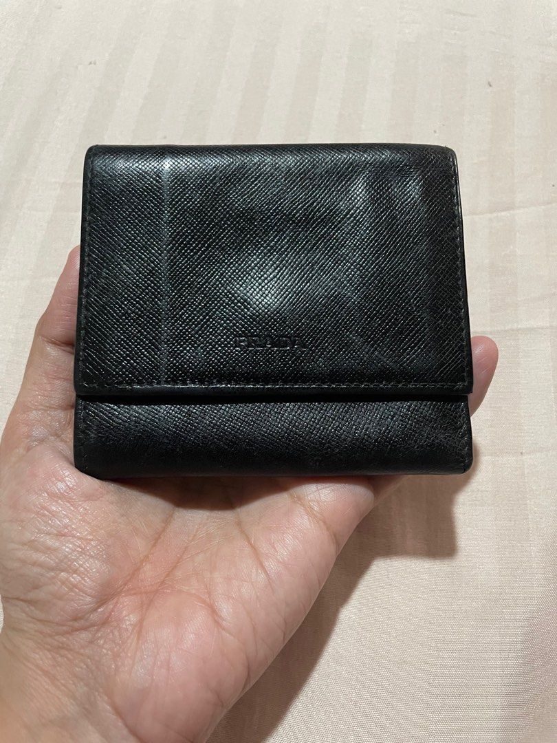 PRADA small leather wallet (Category: Luxury Bags & Wallets) located in San Pablo. Submitted by prelovedbymistyblue (Listing ID 1349049569, Image 1). Description: Authentic small Prada trifold leather wallet. No major flaws except some signs if use on the leather with slightly loose button lock. With coin slot. Number code is heatstamped on the leather . Bought from Japan. Measures 3.6 x 3 incheswhen folded. Selling low for 3600, down to 3000 .