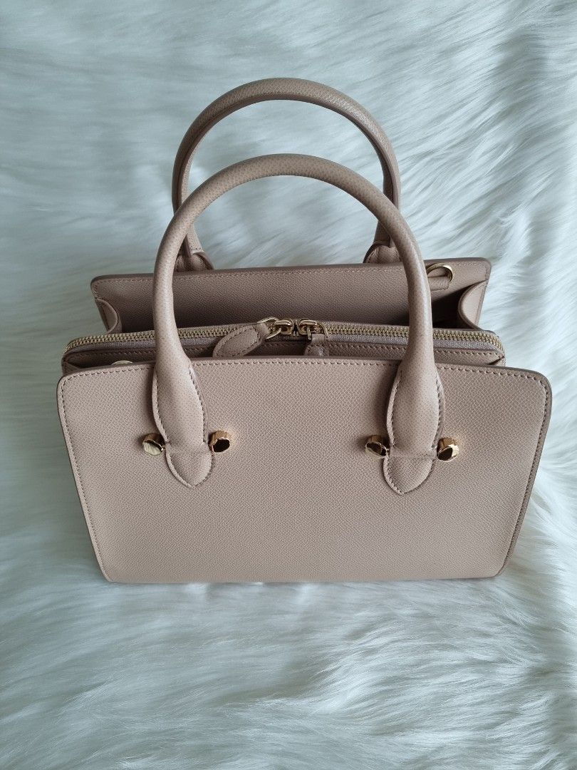 Salvatorre Ferragamo (Category: Luxury Bags & Wallets) located in Manila. Submitted by facet.ornament (Listing ID 1349321073, Image 2). Description: Authentic 👜💯🪭 Salvatore Ferragamo Today Satchel Leather Small Dimension: 11"W x 8.5"H x 5"D Top Handle: 4" handle drop Strap: 20-22" strap drop Exterior Material: Leather Interior Material: Satin Bag Color: Creamish beige Hardware Color: Gold Inclusions: Dust bag, detachable strap, and Legit Grail