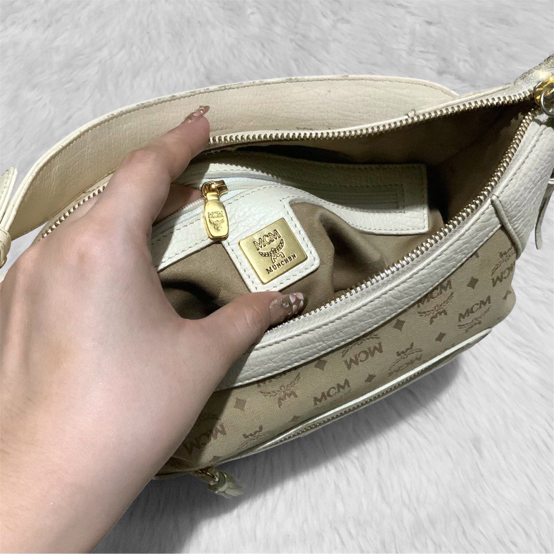 MCM Vintage Canvas-Leather Shoulder Bag (Category: Luxury Bags & Wallets) located in Bulacan. Submitted by sweetmarijane (Listing ID 1349360467, Image 3). Description: ~ Color: Cream/Ivory ~ Turnable screw, ykk zip, germany ~ Personal Collection ~ Rare finds ~ Looks new ~ Signs of usage ~ Minimal rubs on the handle/corners ~ Minimal fading/hairlines on the hardwares 💛Guaranteed Authentic 🧡Please no lowballing! 🤎All the details are in the photo