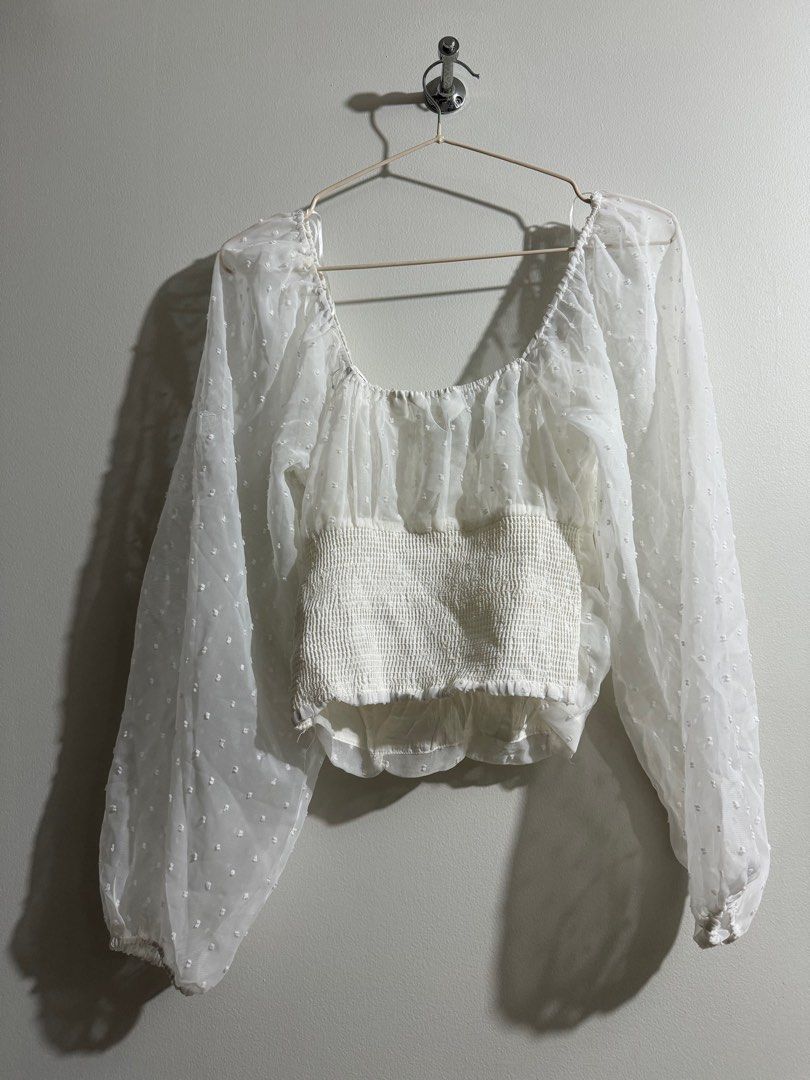 White Polka Bustier With Sheer Sleeves (Category: Blouses) located in Makati City. Submitted by danandy12 (Listing ID 1349538361, Image 2). Description: Bought in Australia. Cute and flattering! 🩷 Emphasizes cleavage without showing too much. Sophisticated and can still be formal if paired well with accessories. Size: S RFS: Doesn’t fit me anymore .