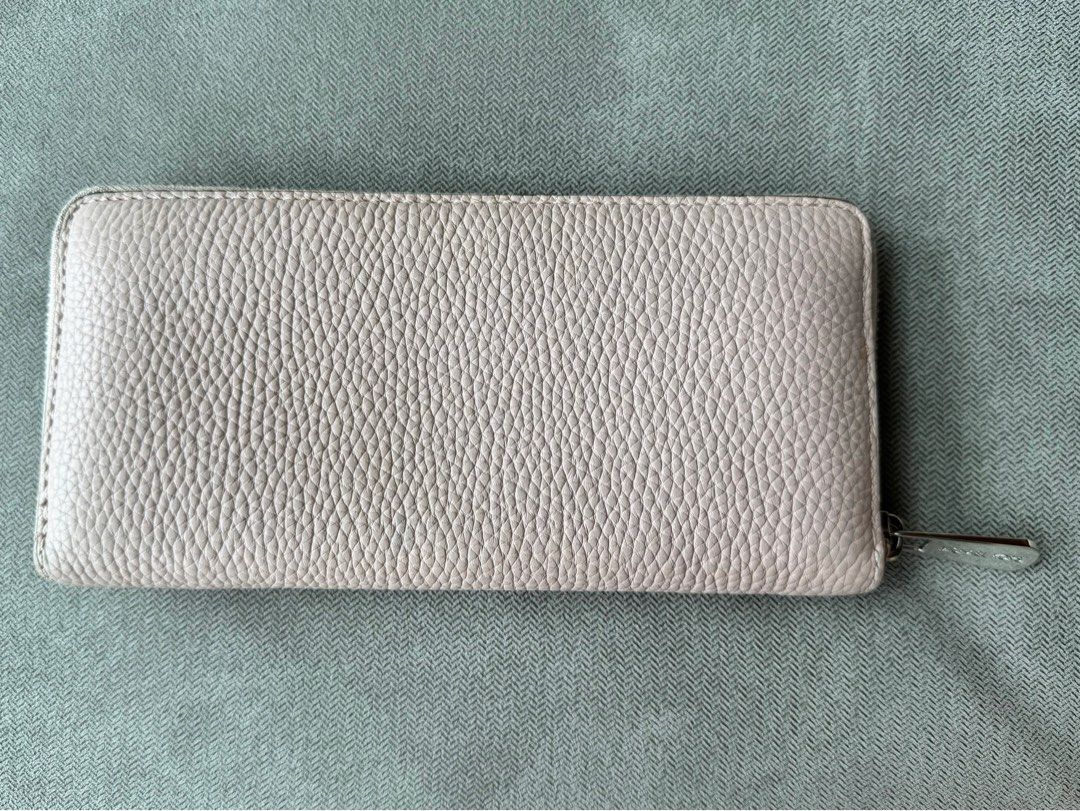 Michael Kors MK Blush Long Wallet (Preloved) (Category: Luxury Bags & Wallets) located in Quezon City. Submitted by __J__ (Listing ID 1350130945, Image 2). Description: Preloved original Michael Kors pebbled leather zip around long wallet. The interior is lined with Michael Kors signature lining. There are 8 small credit card slots, 2 large slip pockets on each side, and a coins zipper pocket. Approximately 8”l x 4”h. Condition: Used with care, w
