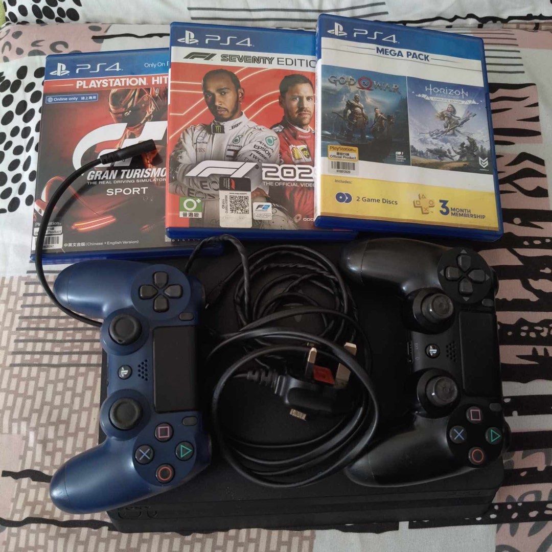 PS4 Slim 1TB (Category: PlayStation) located in Quezon City. Submitted by magmacastles (Listing ID 1350090712, Image 1). Description: Working. Complete package with games. With 2 original controllers, 1 black original with box, 1 blue bought. Black controller both joysticks has no rubber grip. Four games included, Gran Turismo Sport, F1 2020, God of War and Horizon: Zero Dawn. Original bith power cable & controller charger. Disclaimer: 3month pla