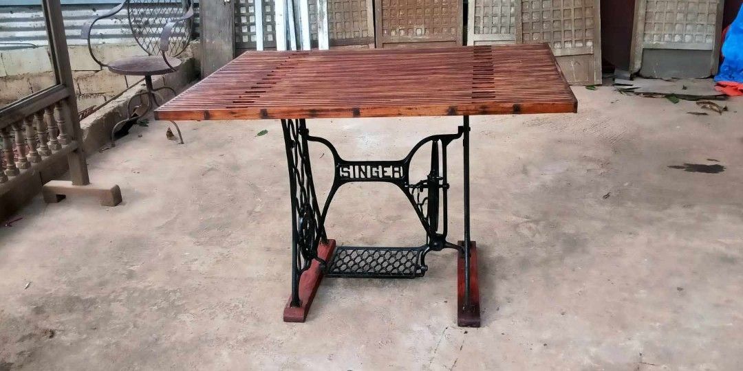 Slatted Table top in sewing machine stand (Category: Tables & Sets) located in Rizal. Submitted by mommykiee (Listing ID 1350126322, Image 1). Description: Old Sewing Machine Stand repurposed into table Table top made of slatted narra wood Size: L45 W33 H30inch Newly stripped & varnished Ready to use.