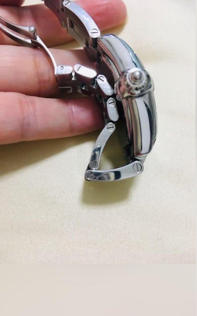 Fire Sale Rare Authentic Cartier Watch No Longer In Production (Category: Watches) located in Singapore. Submitted by blue_jasmine (Listing ID 1345282482, Image 3). Description: Cartier Roadster 💯% Authentic 32mm x 29mm One of the top luxury dress watches Very substantial thick body like AP Stainless steel Silver-tone Tonneau face Roman numeral dial Sword Hands The prominent watch crown is signature Cartier In great perfect working condition Ver