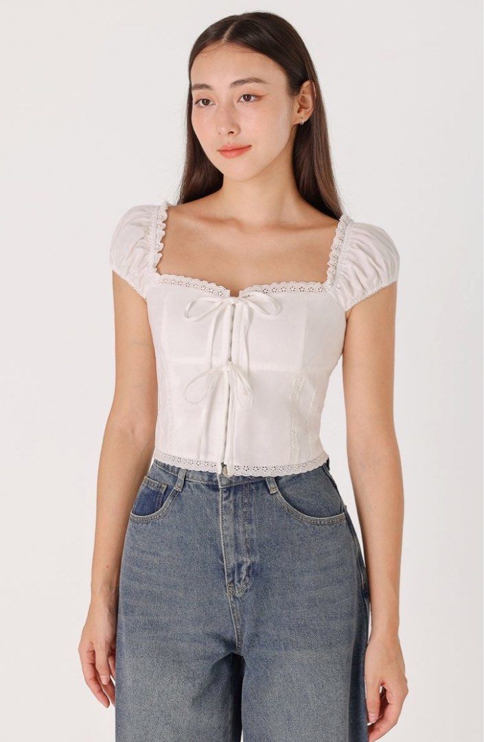 LOVET CIERA PADDED RIBBON CORSET CAP SLEEVE IN WHITE (Category: Blouses) located in Singapore. Submitted by snowpom (Listing ID 1345221217, Image 1). Description: very flattering! BNWT :) size XXS.