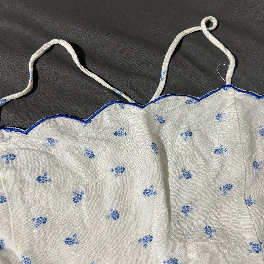 Blue white floral scallop top (Category: Sleeveless) located in Quezon City. Submitted by p0lingkit (Listing ID 1350242115, Image 2). Description: • see pic for measurement • fabric is soft, not sure if its cotton or linen • i dont use it anymore • no when worn • strap is adjustable Not sure if zara or h&m hehe.