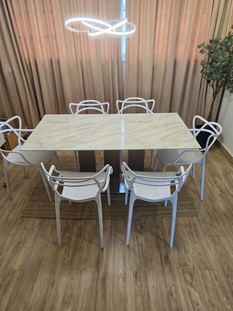 Dining Table Set (Category: Tables & Sets) located in Singapore. Submitted by 008iilt (Listing ID 1350280204, Image 2). Description: Marble Table with stainless steel legs Note that the stainless steel legs can be cleaned by polishing and small chip on table. Measurements: 160cm x 80.5cm x 50cm Comes with 6 white chairs .