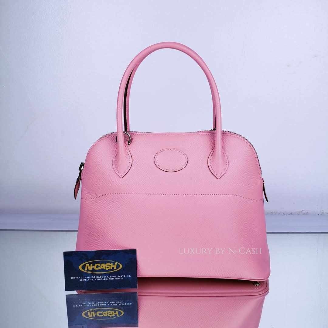 Hermes Bolide 27 Bubblegum Epsom (Category: Luxury Bags & Wallets) located in Quezon City. Submitted by luxury_by_n-cash (Listing ID 1350245463, Image 1). Description: N-Cash Pawnshop "Instant Cash for Bags, Watches, Cars, and Electronics" https://www.ncash-pawnshop-philippines.com/ Hermes Bolide 27 Bubblegum Epsom PRE-OWNED Material: Bubblegum Epsom Hardware: Palladium Made in France Stamp: X ITEM INCLUSIONS Detachable Strap, Dust Bag, and Lock 