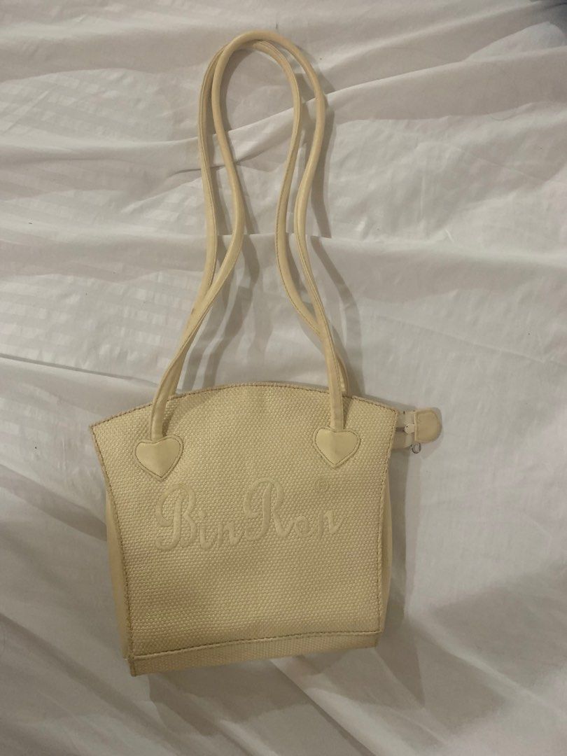 Bin Ron Yellow Cream Long Shoulder Bag (Category: Shoulder Bags) located in Manila. Submitted by mlbdll (Listing ID 1345494384, Image 1). Description: Bought this from an IG shop back then for 150 PHP but i havent used it once since it doesnt actually match what i usually wear (outfits) :( There are no flaws but it is indeed dirty so it needs cleaning If you want more pics of it, just dm me! :) .